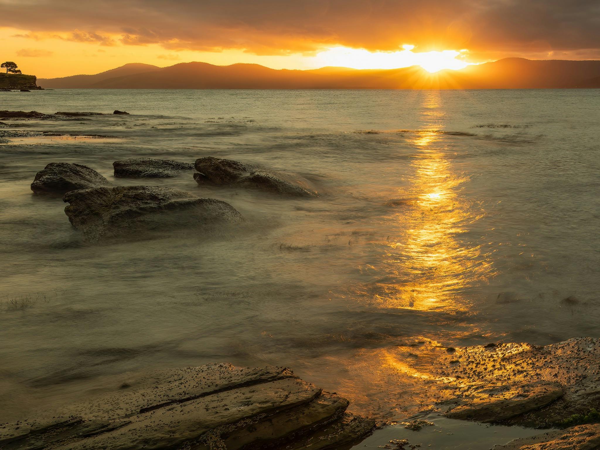 a coastal scene at sunset