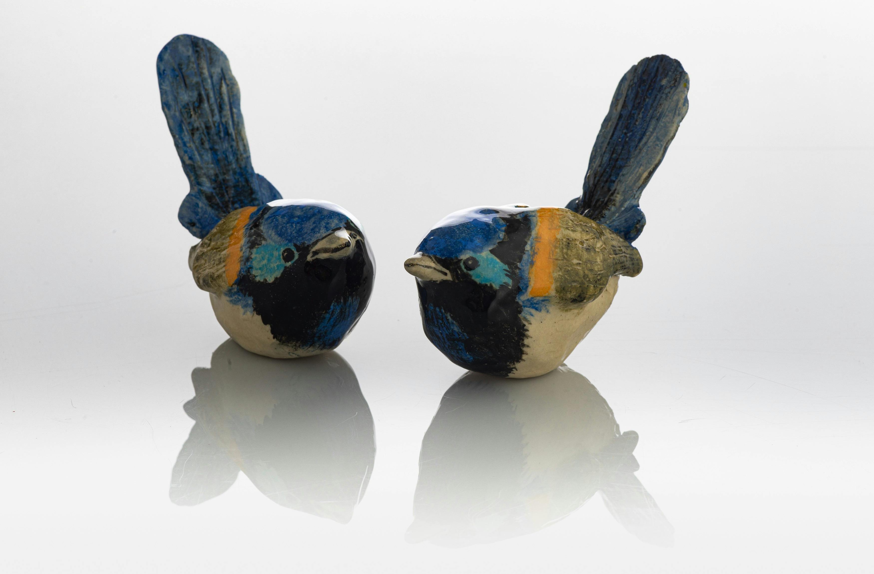 two ceramic wrens made at the workshop