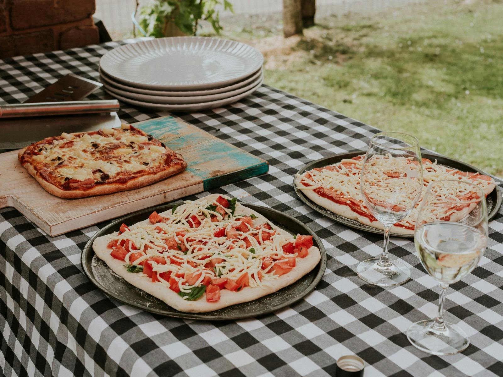 A table with pizza and wine