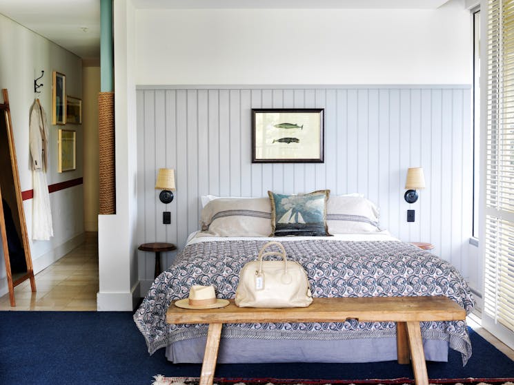 A king bed in a beach-side hotel room