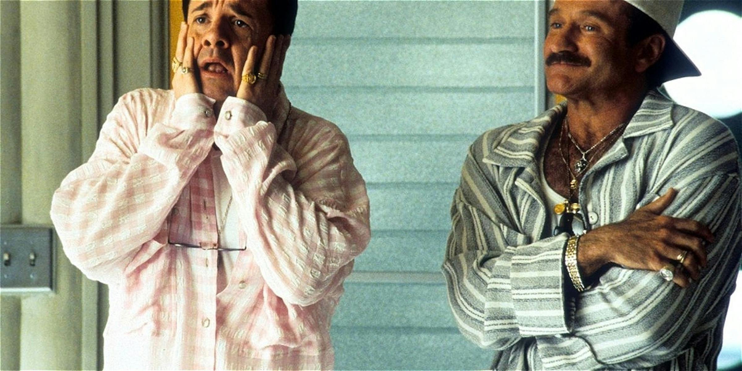 Two men stand in frame with different expressions.