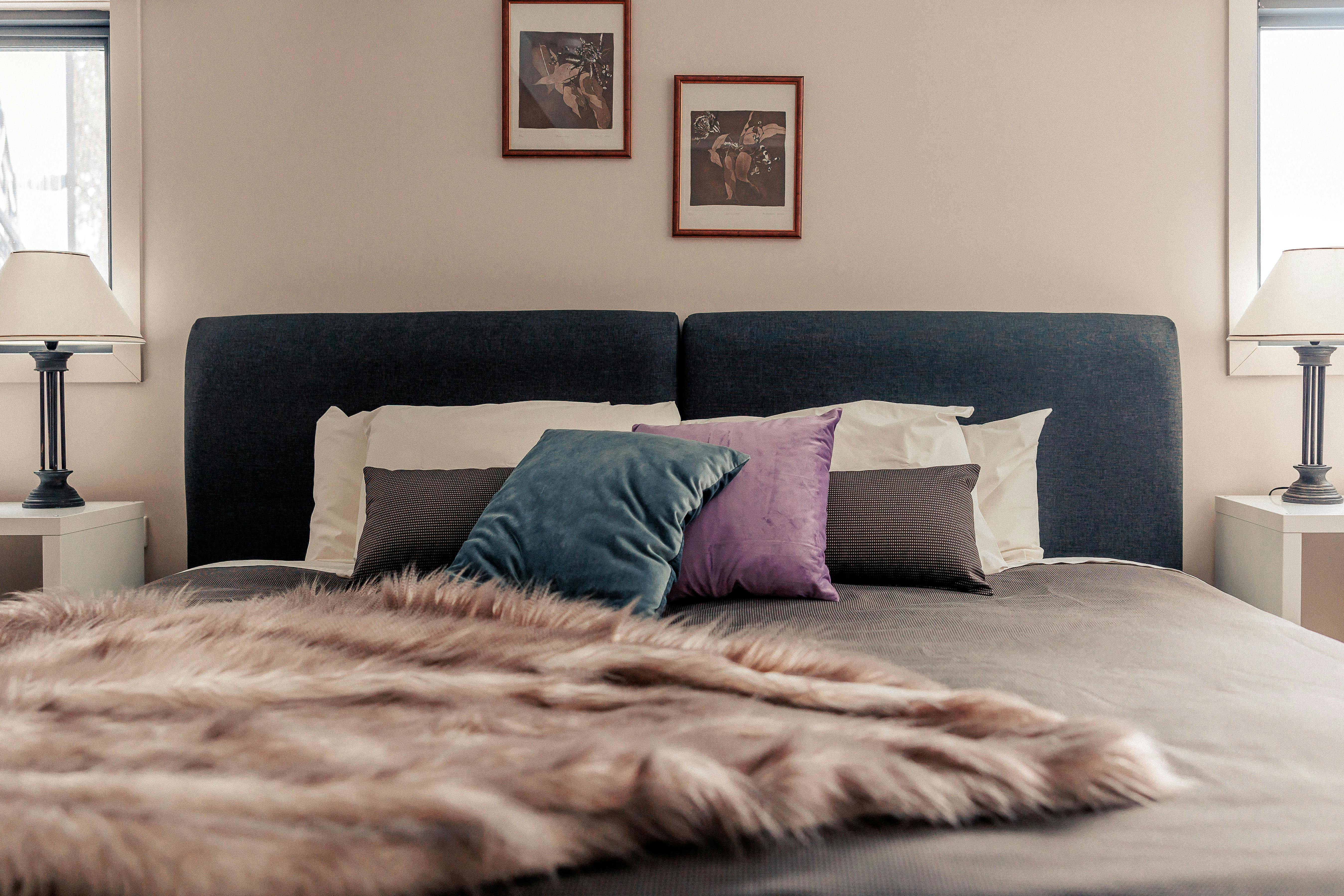 Super King bed with throw and cushions