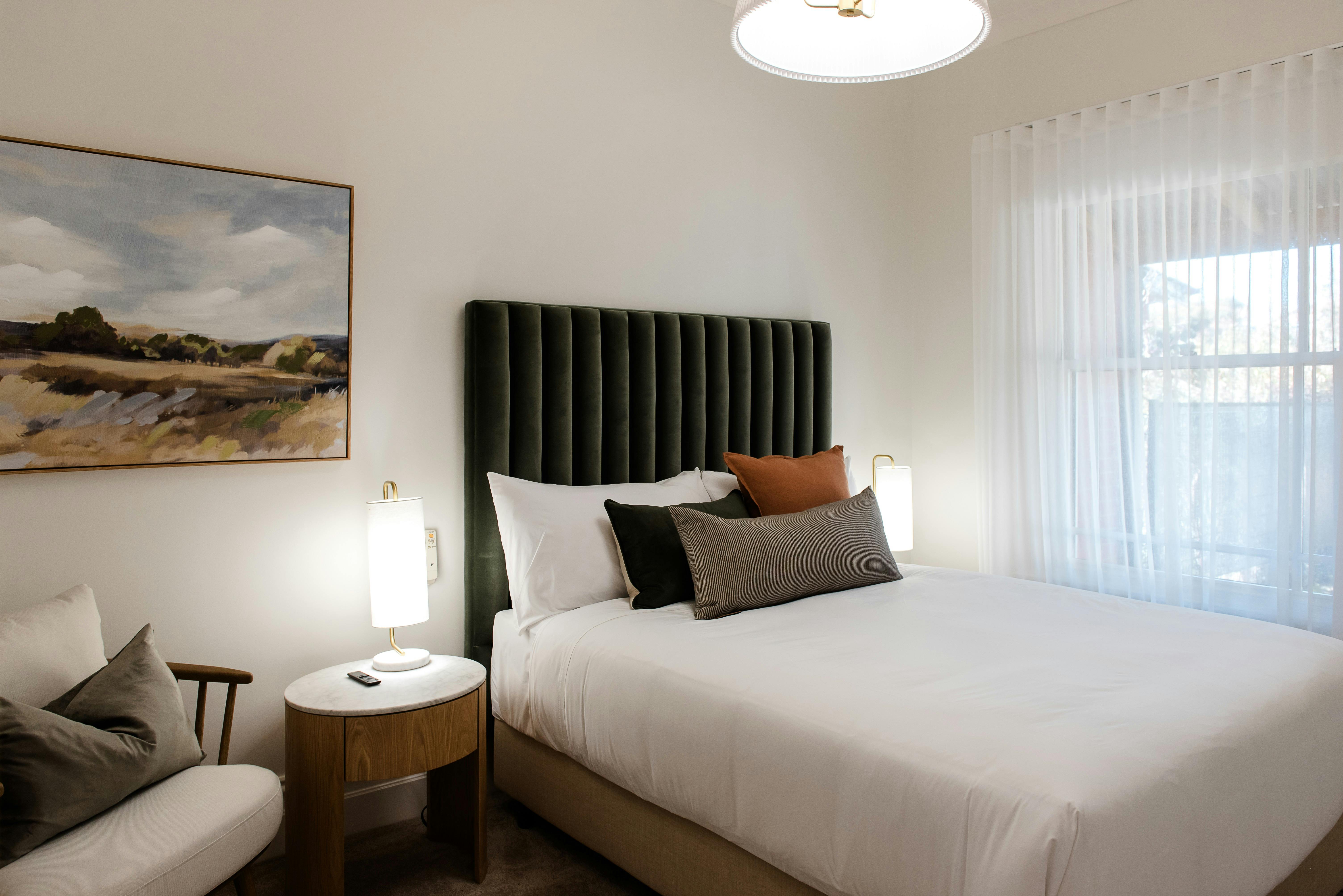 Beautifully presented bedroom with gentle lighting, soft furnishings and cosy vibes in Wangaratta