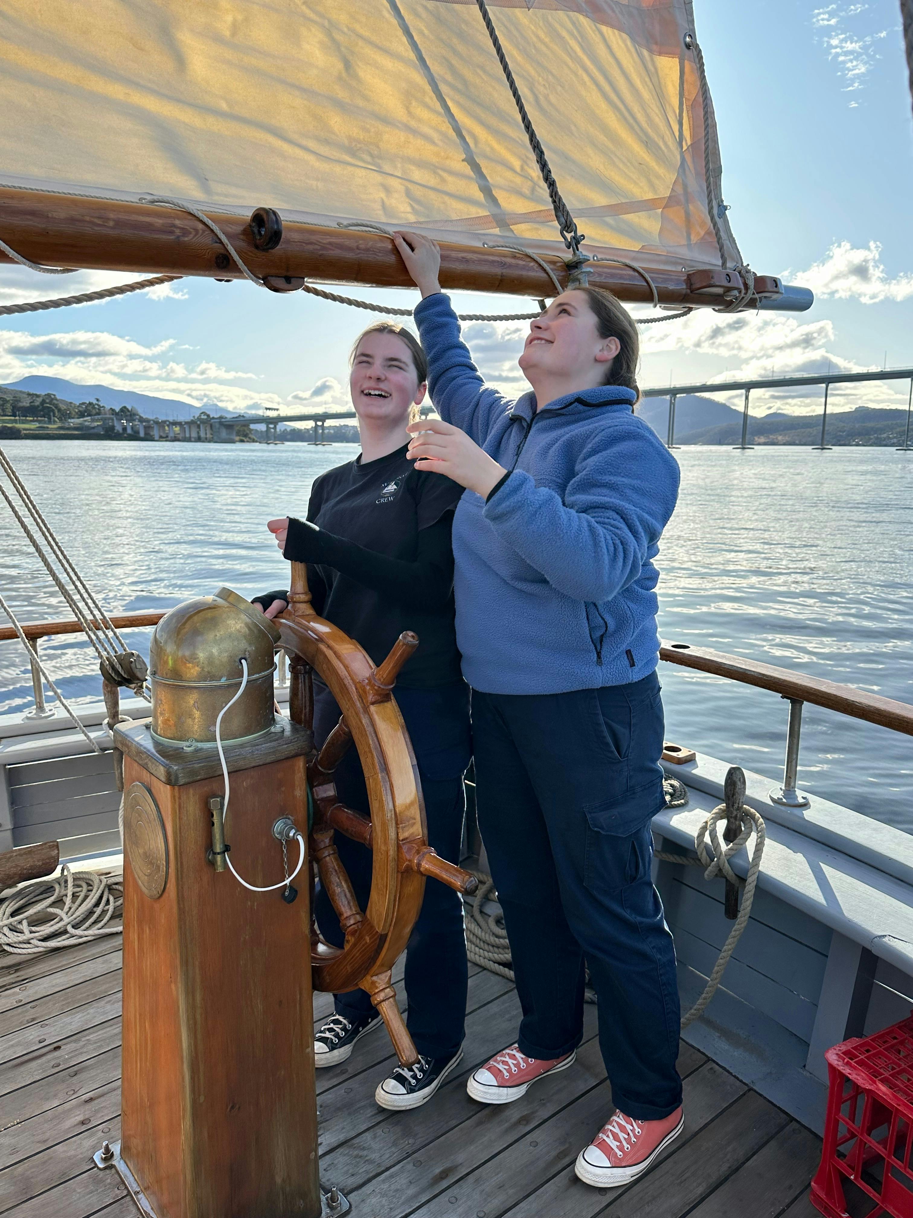 Two of the youth crew steering the ship