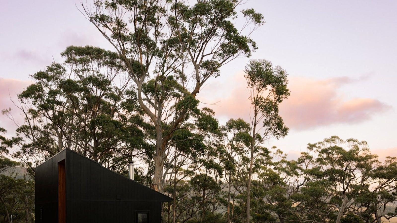 Image of Hunter Huon Valley exterior and deck against striking bushland backdrop