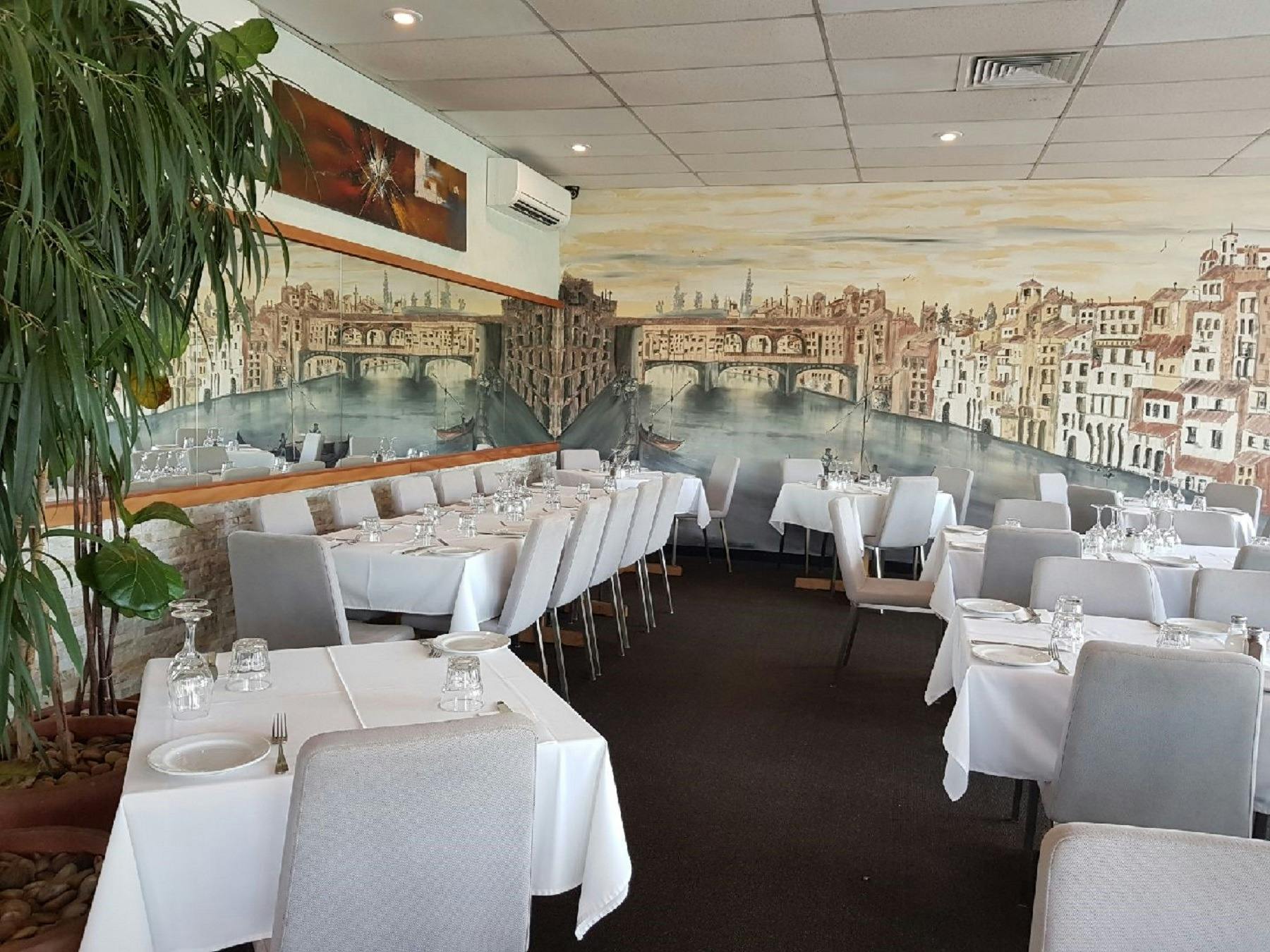 Empty restaurant setting with mural on wall