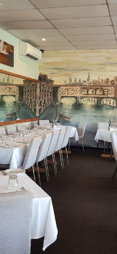Empty restaurant setting with mural on wall