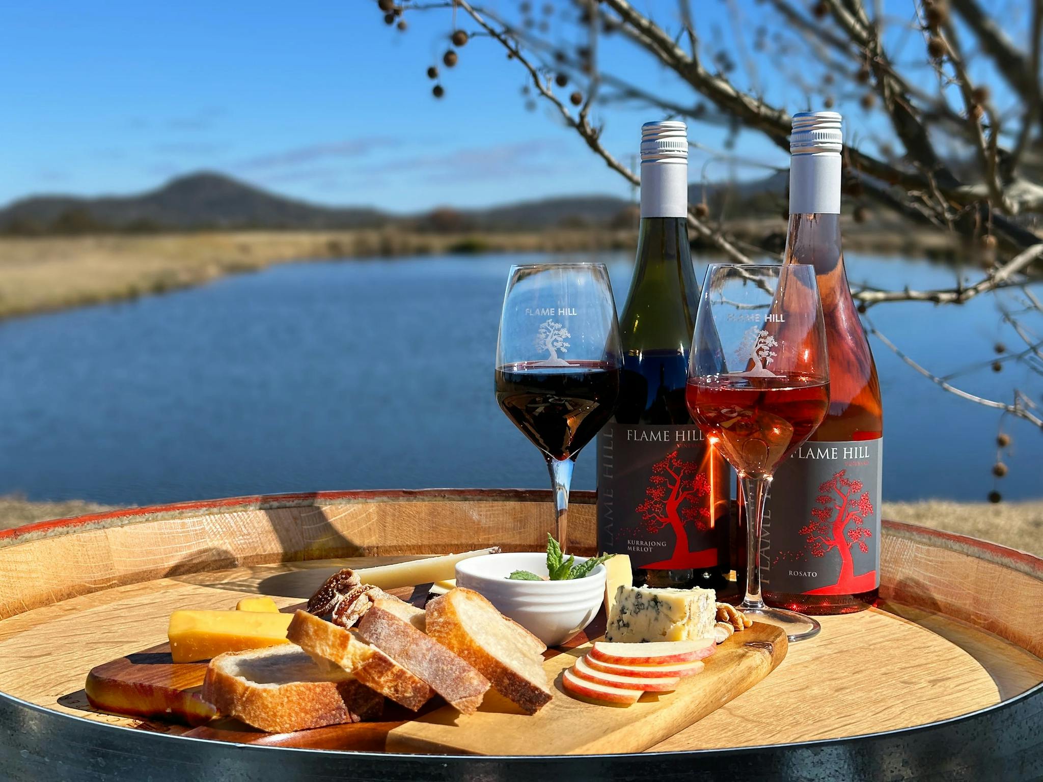 Cheese board and wine, Queensland wine on barrel, glass of red granite belt, scenery granite belt Cheese board and wine, Queensland wine on barrel, glass of red granite belt, scenery granite belt
