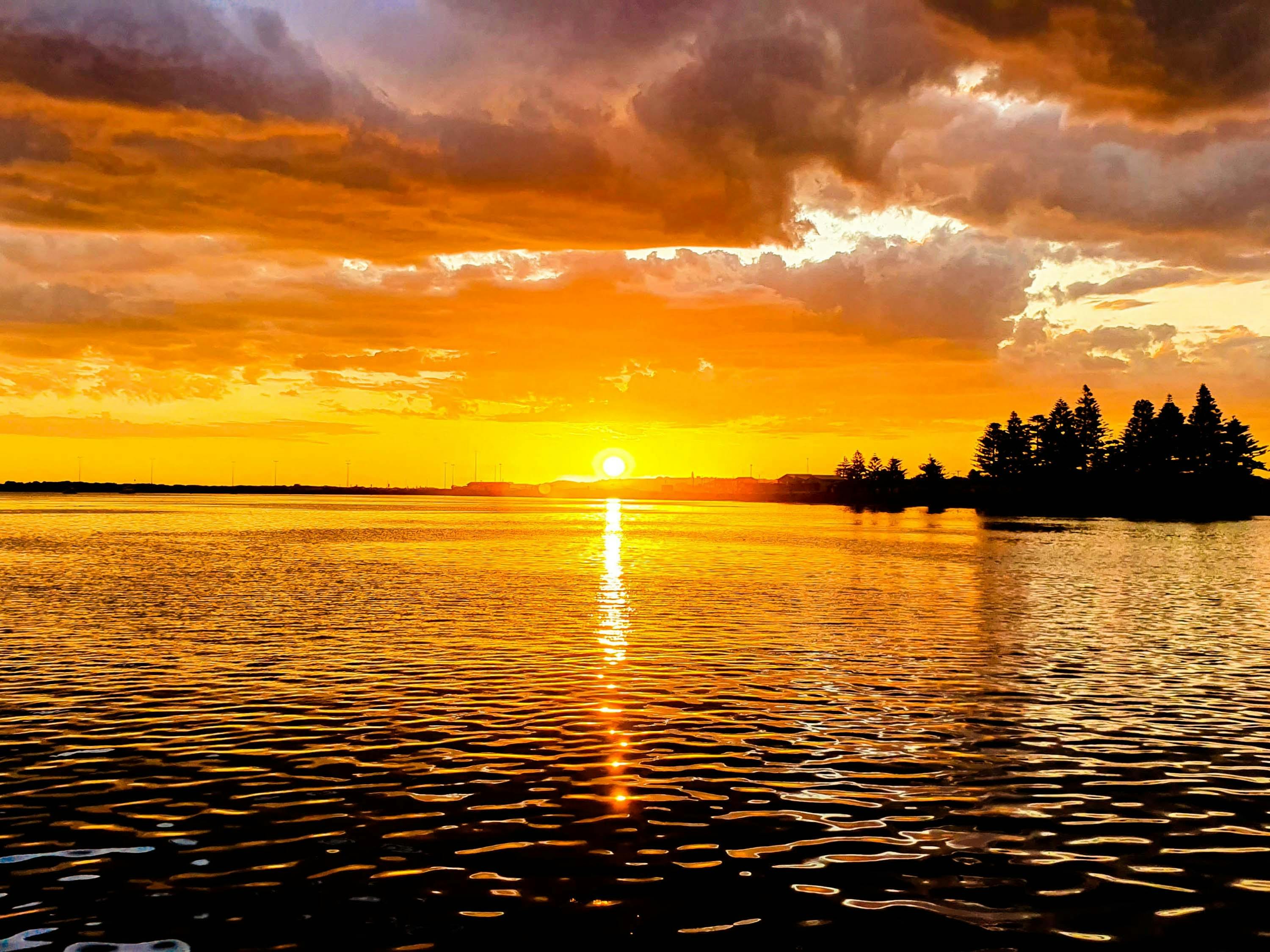Colourful dramatic skies at sunset over Port MacDonnell harbour