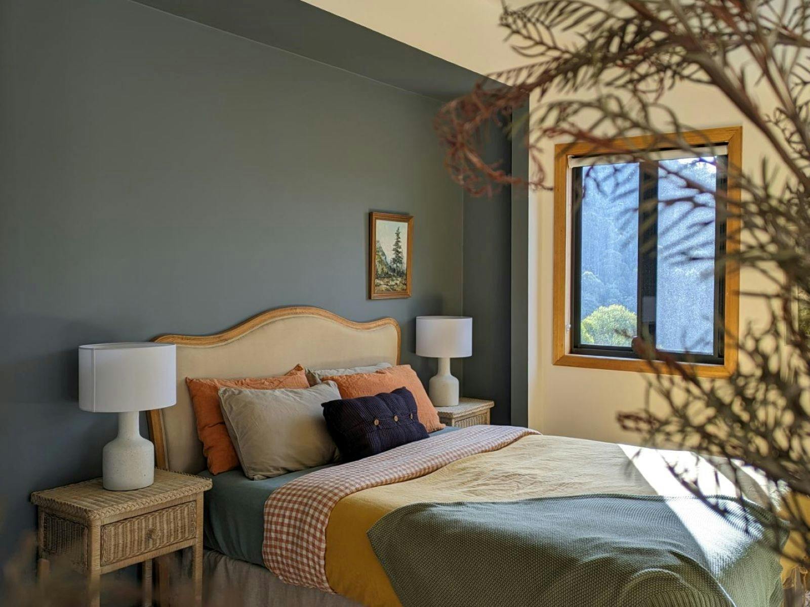 Master bedroom with window views over the mountains and orchards