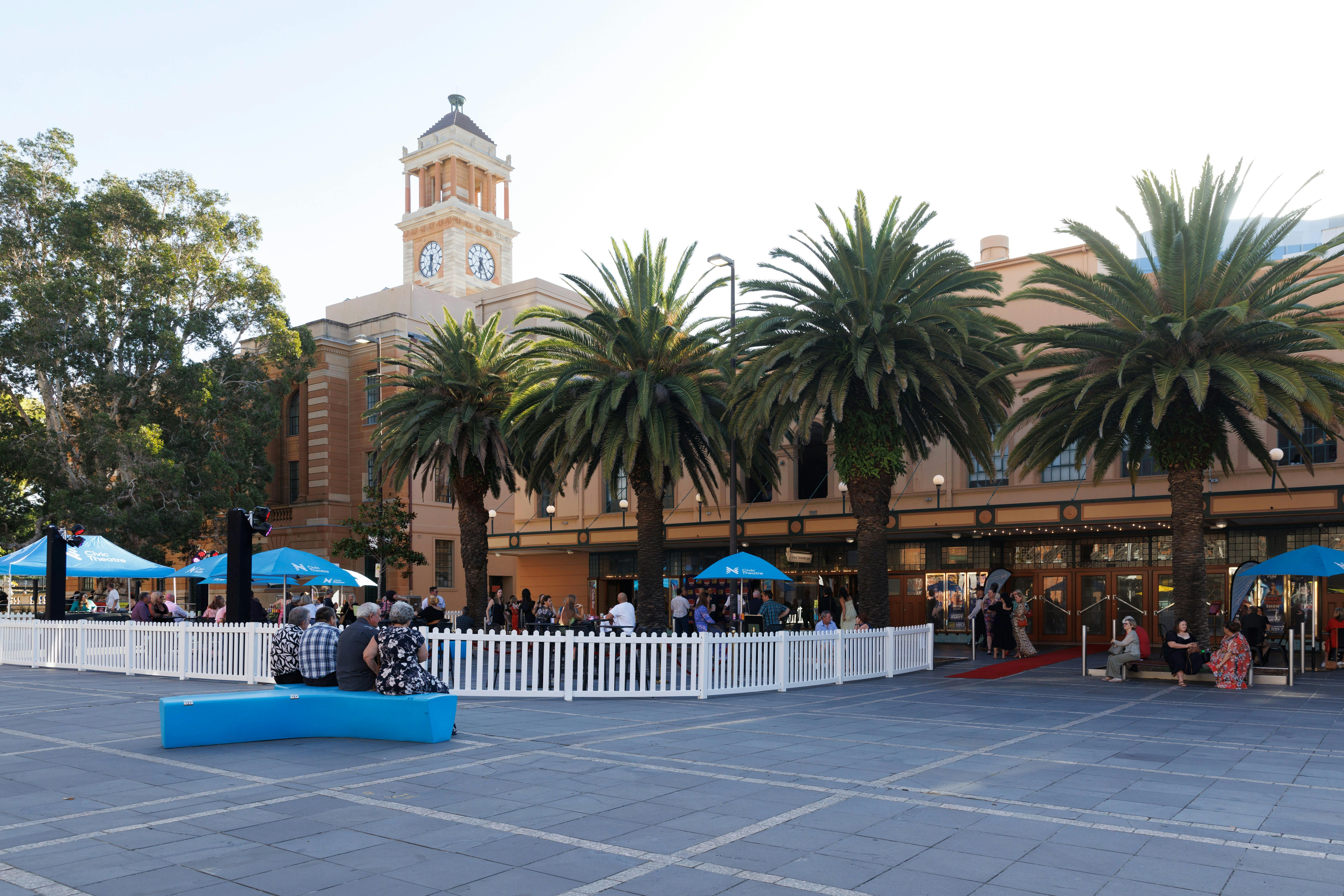 Photo of the Civic Theatre in daylight. A crowd of people stand in front of the theatre.