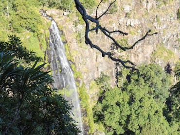 Waterfall tumbling over sheer rock cliff.