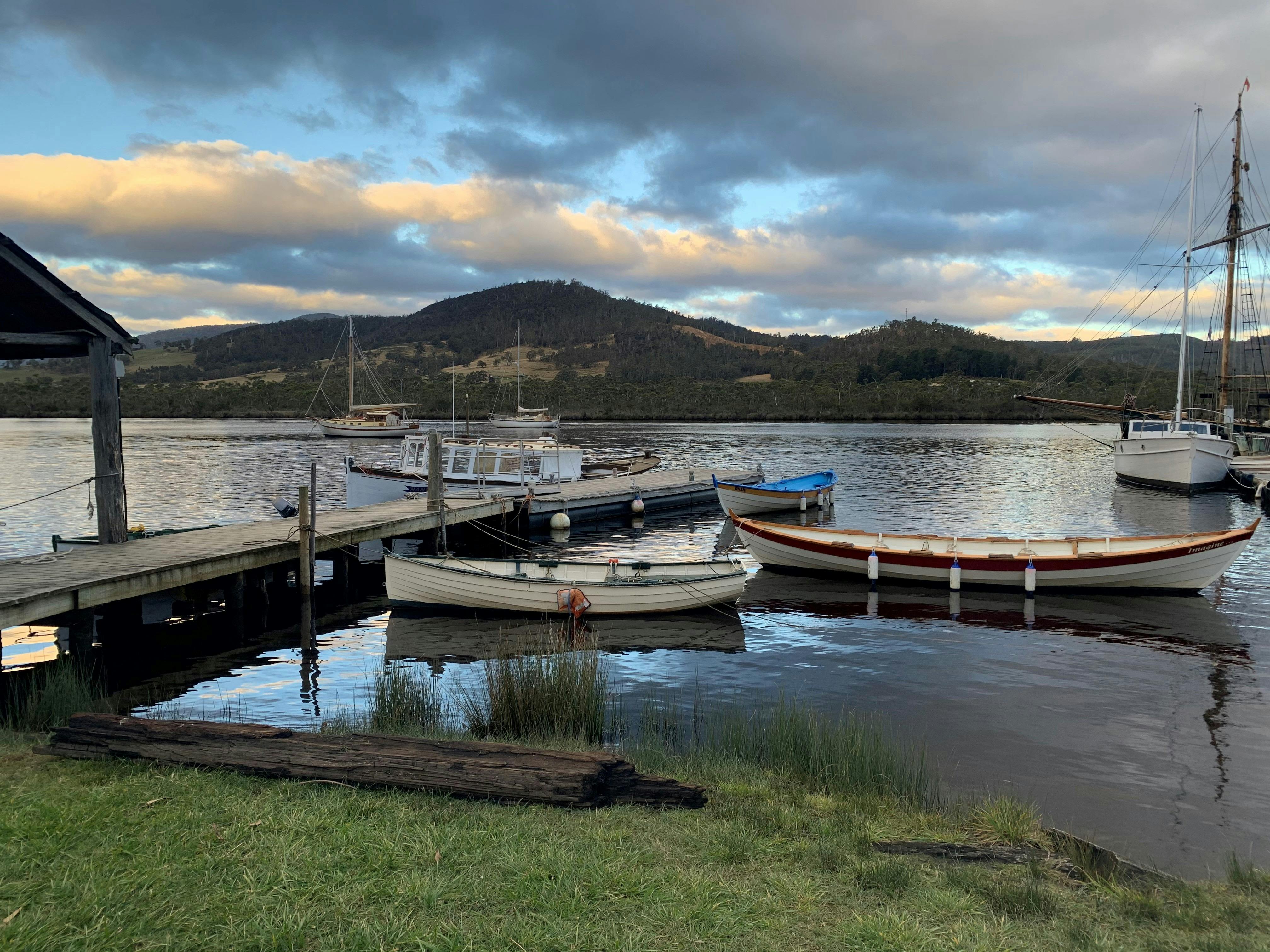 Wooden boats on the tranquil Huon River at Franklin Village
