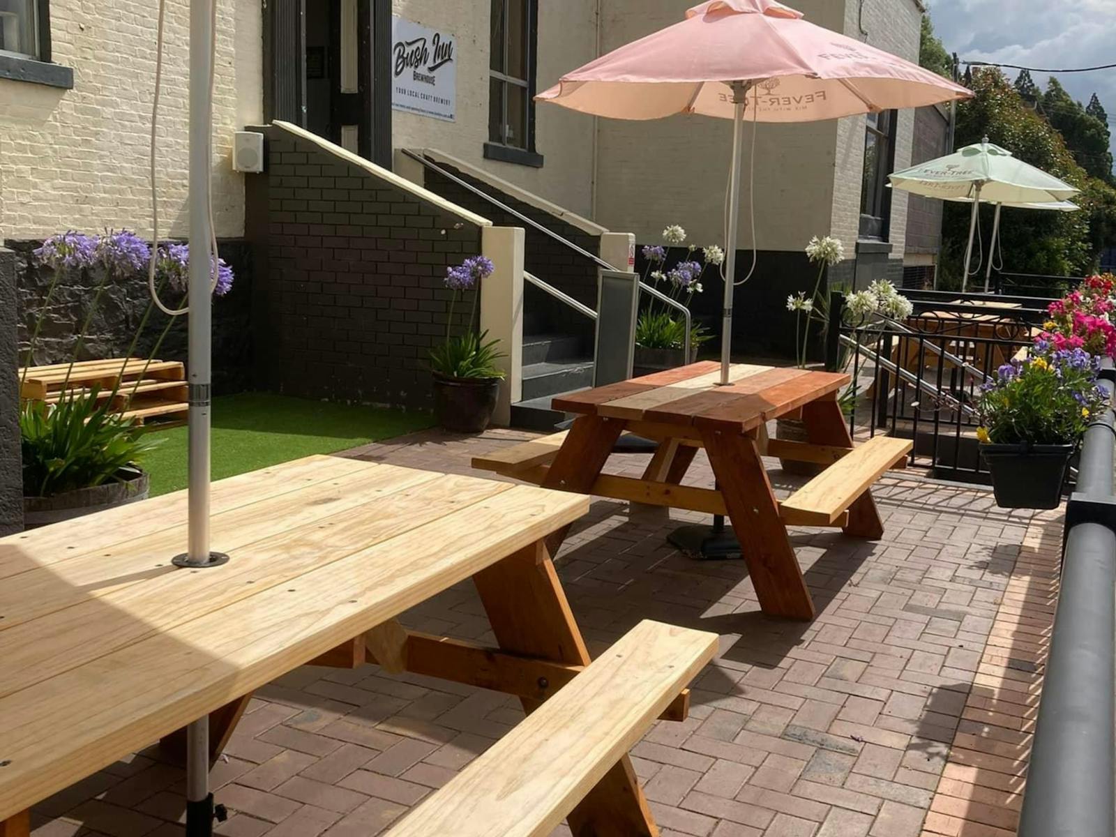 Our front Patio on a sunny day with some tables and umbrellas