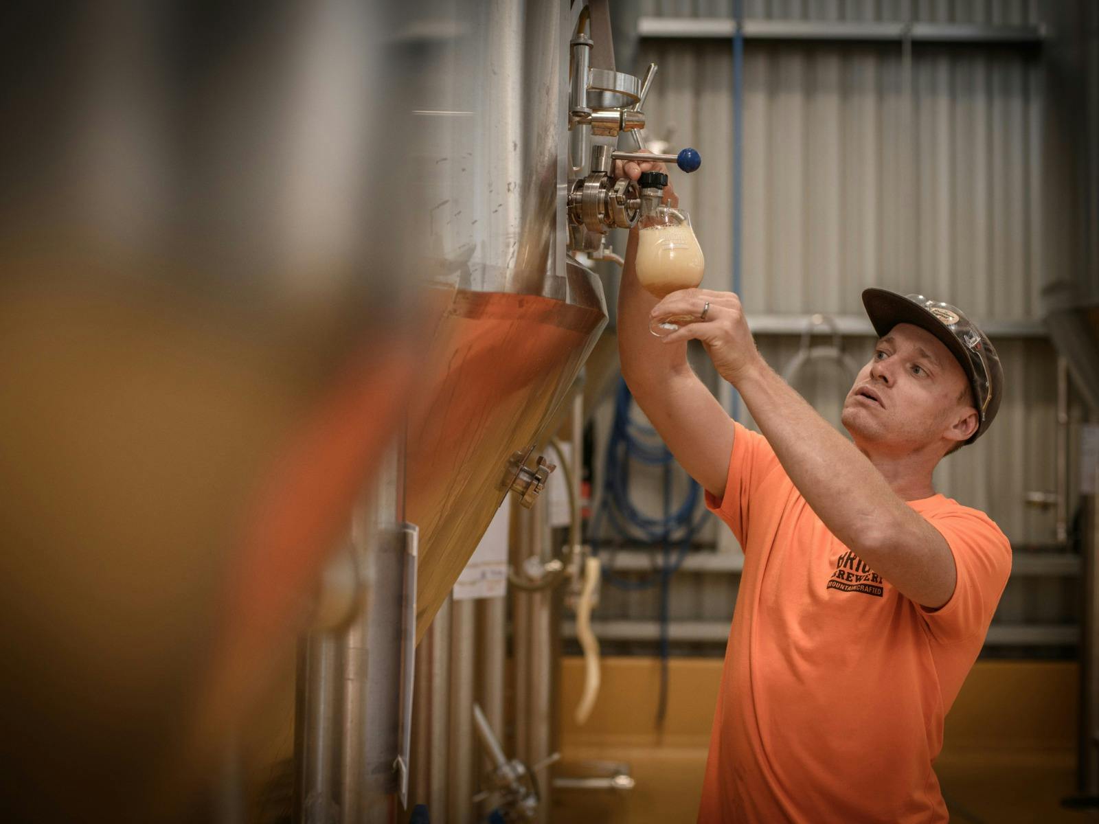 Brewer taking a tank sample