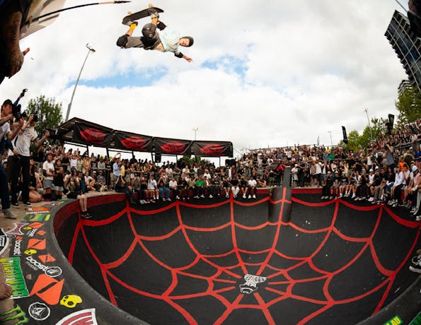 Skateboarder peforming backside air in Belconnen Bowl