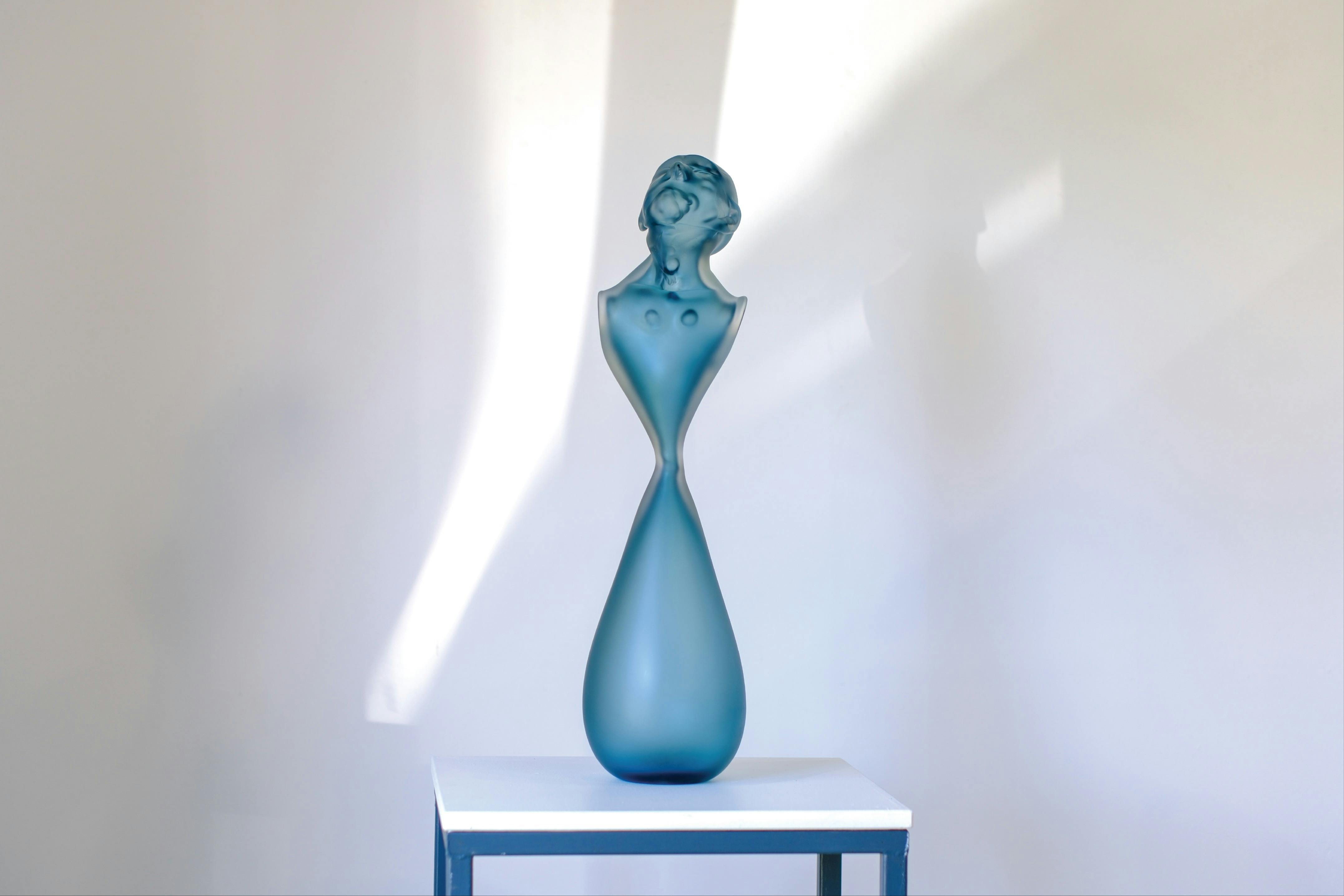 Glass bust looking up in blue