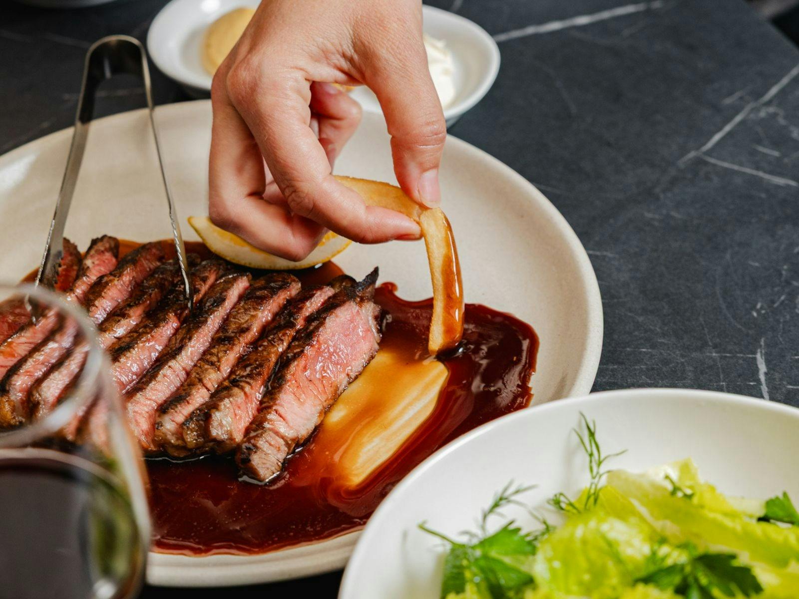 Sliced steak with chip dipped in gravy