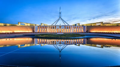 Photo of Australian Parliament House in the evening.