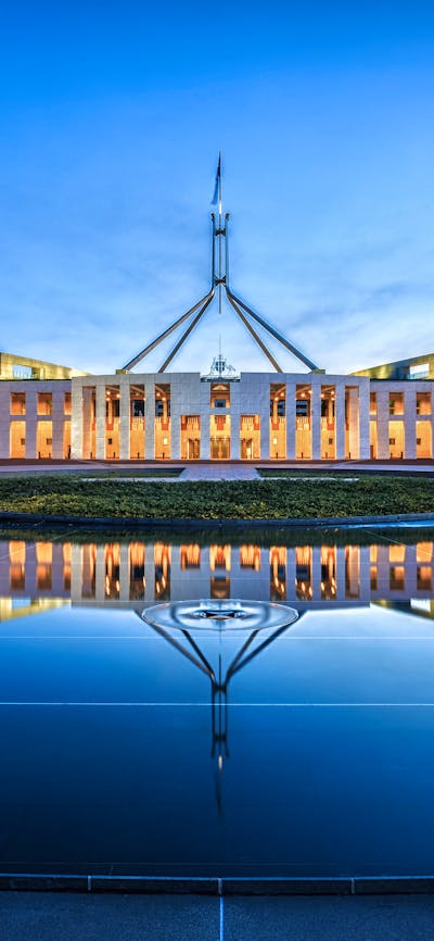 Photo of Australian Parliament House in the evening.
