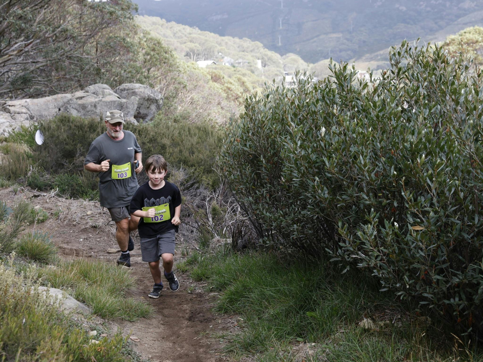 father and son running the mountain trail