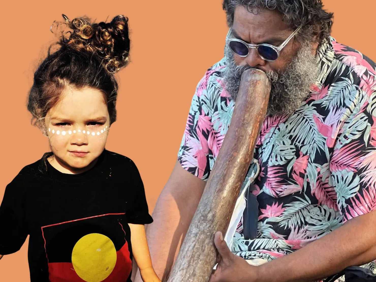 Robby Peters playing the didgeridoo, with toddler, painted up in ochre