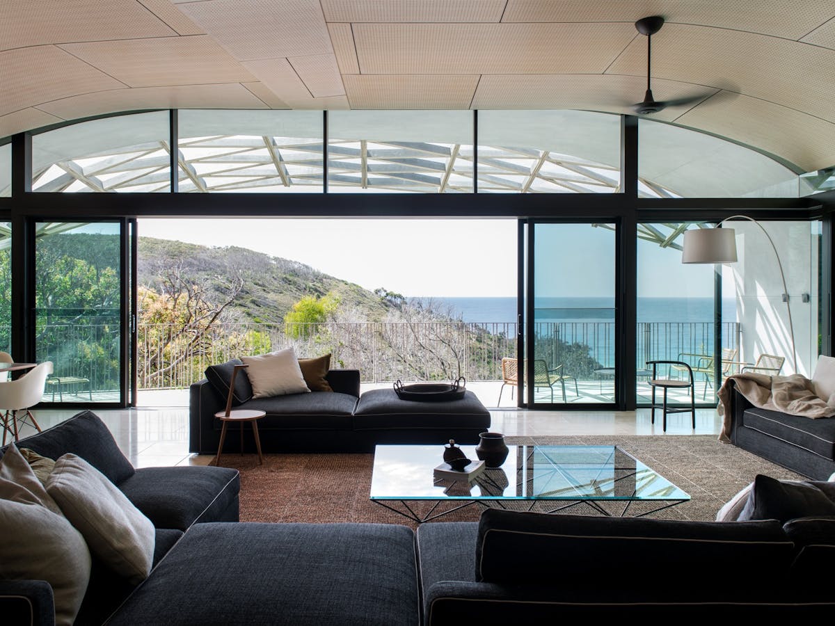 Spacious open-plan living room with modern design and ocean views at Domic Noosa