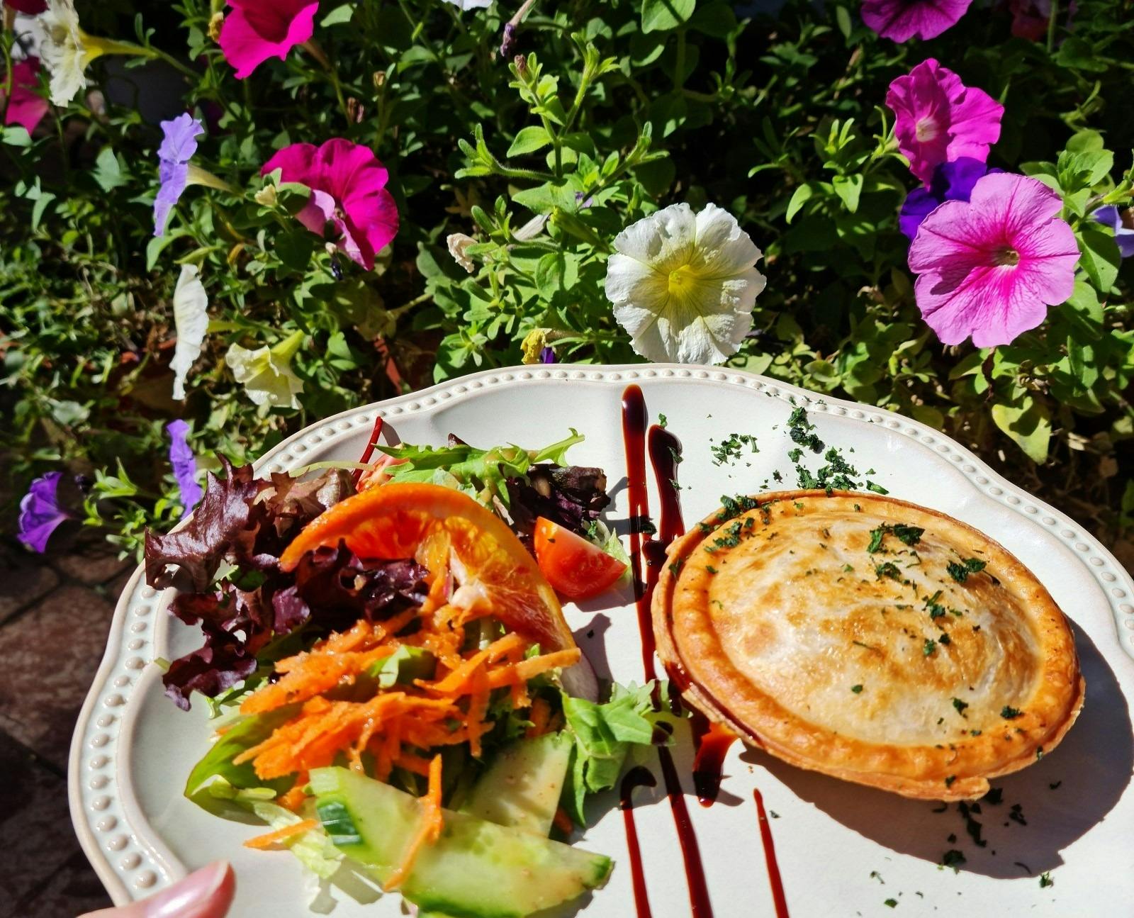 Food on plate with flowers in background