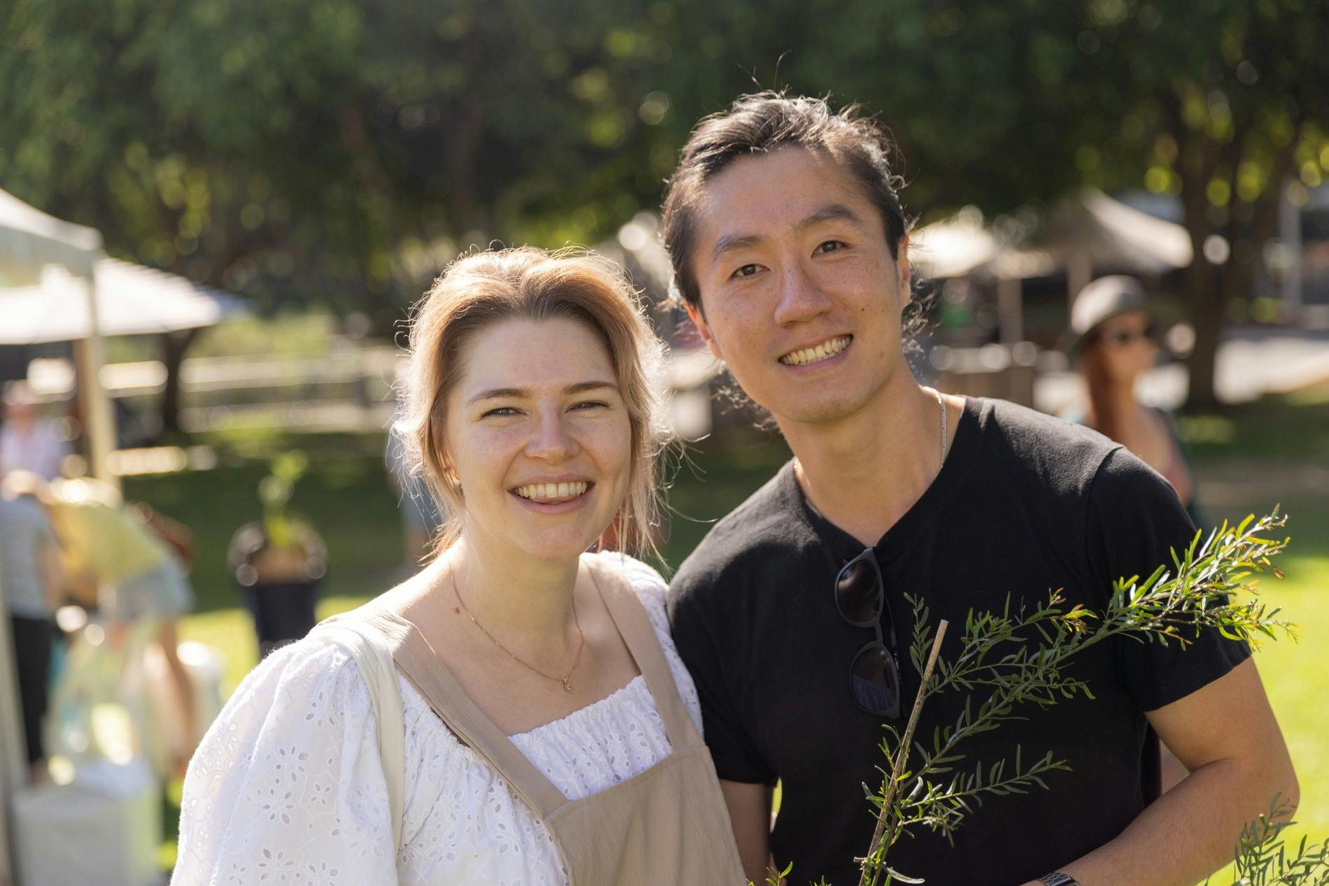 Two people standing together with one of the free native plants at Sustainable BNE Festival