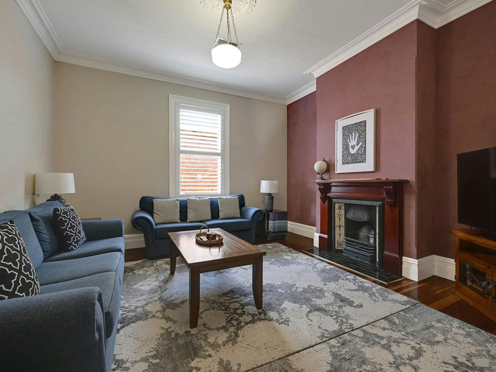 Living room with blue sofas, fireplace and tv