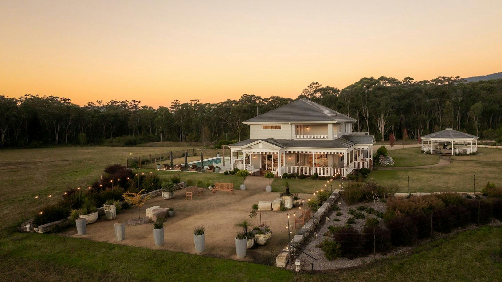 Image of the entire property. Firepit is shown. The entertaining area and the bushland surrounds.