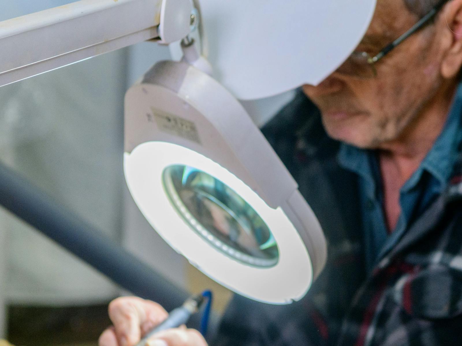 Volunteer uses tools to prepare Dinosaurs