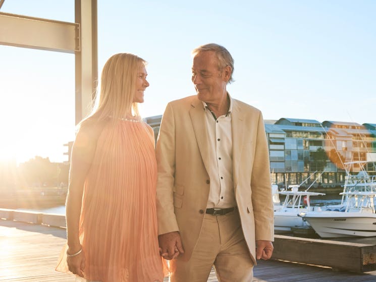 Couple walking by waterside restaurant LuMi Bar & Dining in Pyrmont