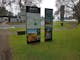 grass, directional signs for rail trail, path, toilet block, seats