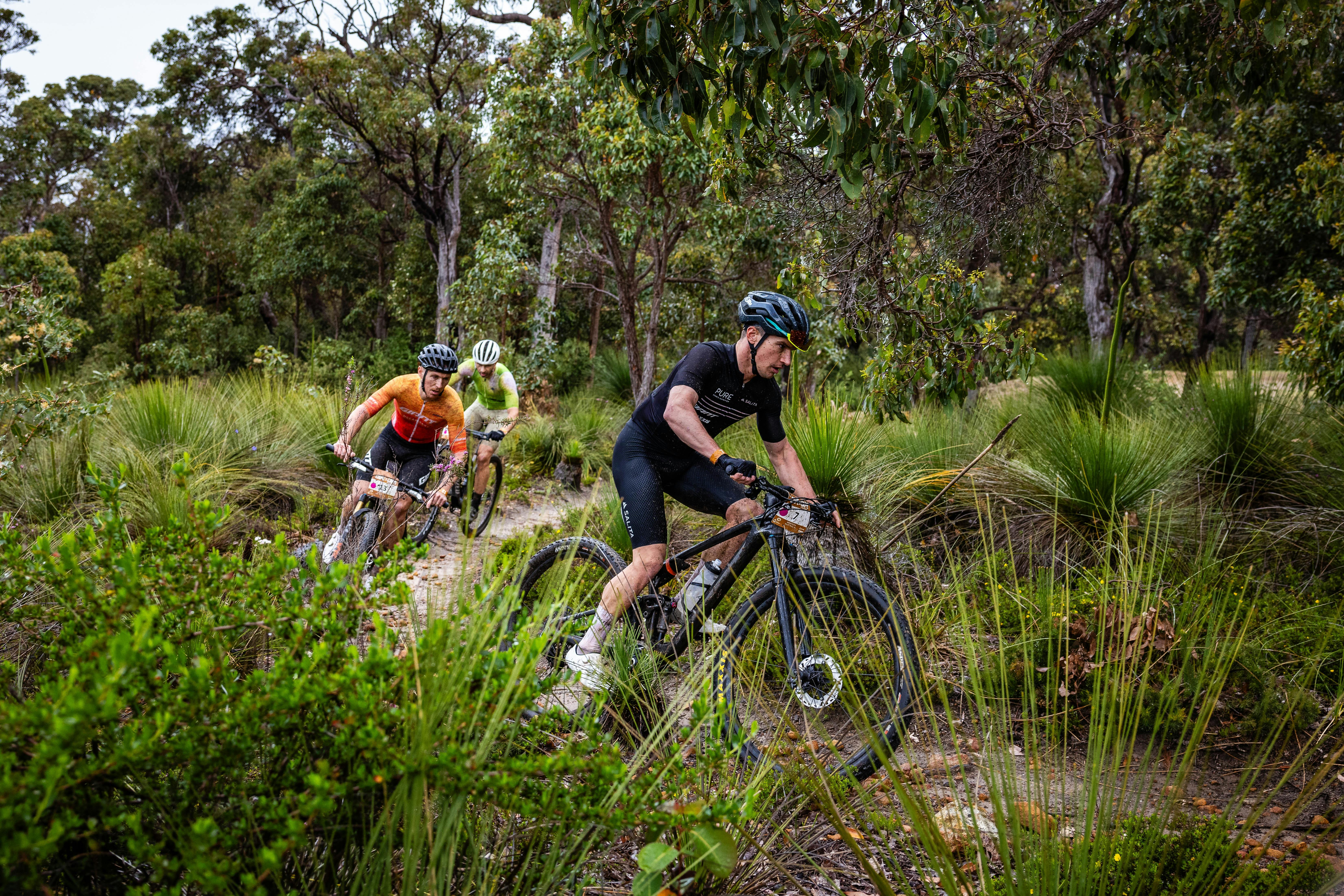 MTB Riders taking a corner of course.