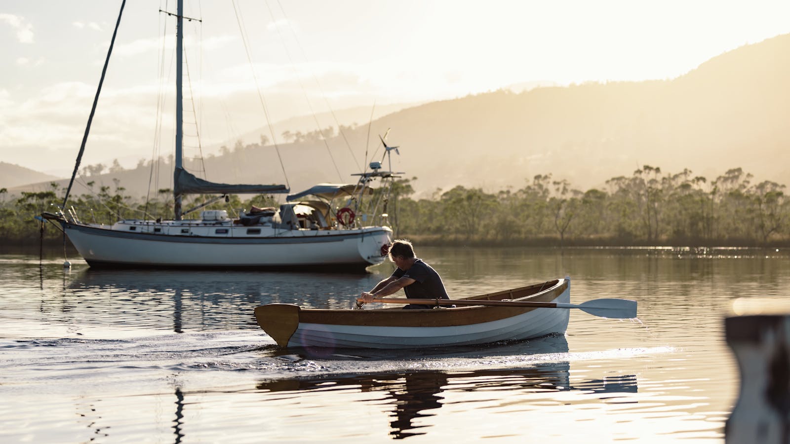 Wooden Boat Centre team member rowing on the Huon