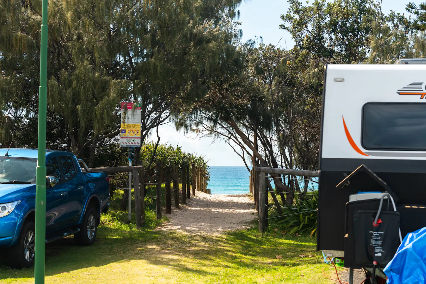 Picture of beach entrance access from caravan park with caravan to the side of frame.
