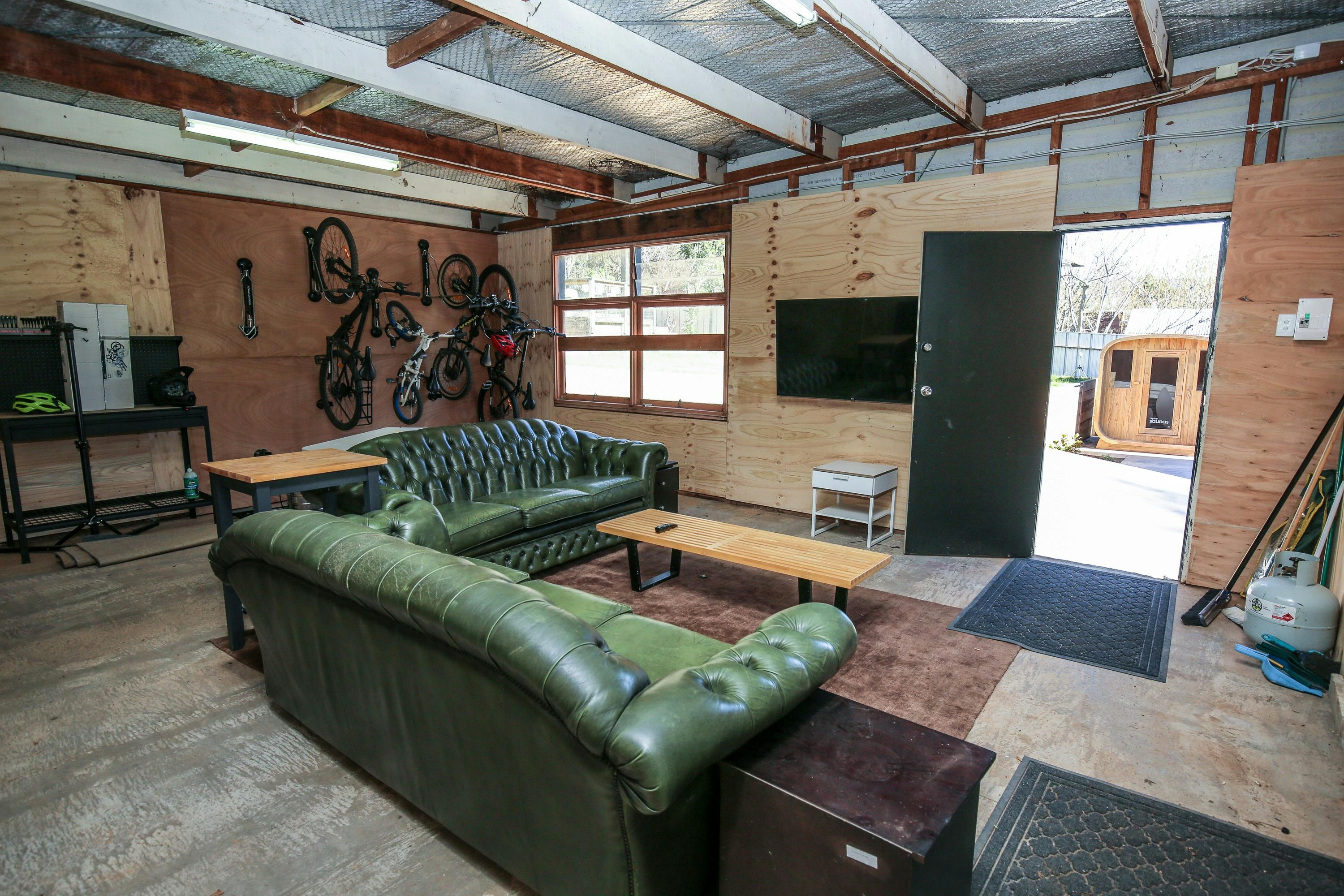 Shed hang out space with TV, bikes and workshop