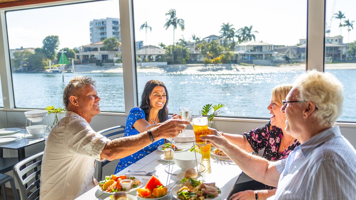 Group of friends cheersing inside a boat