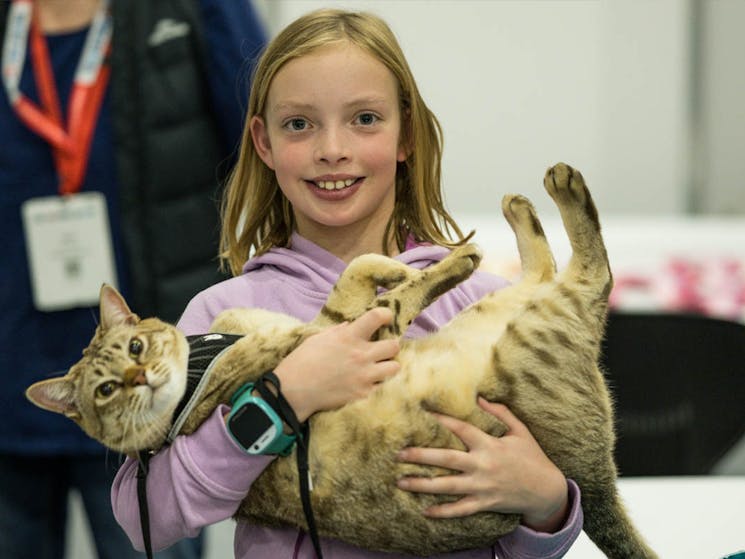 Child holding cat
