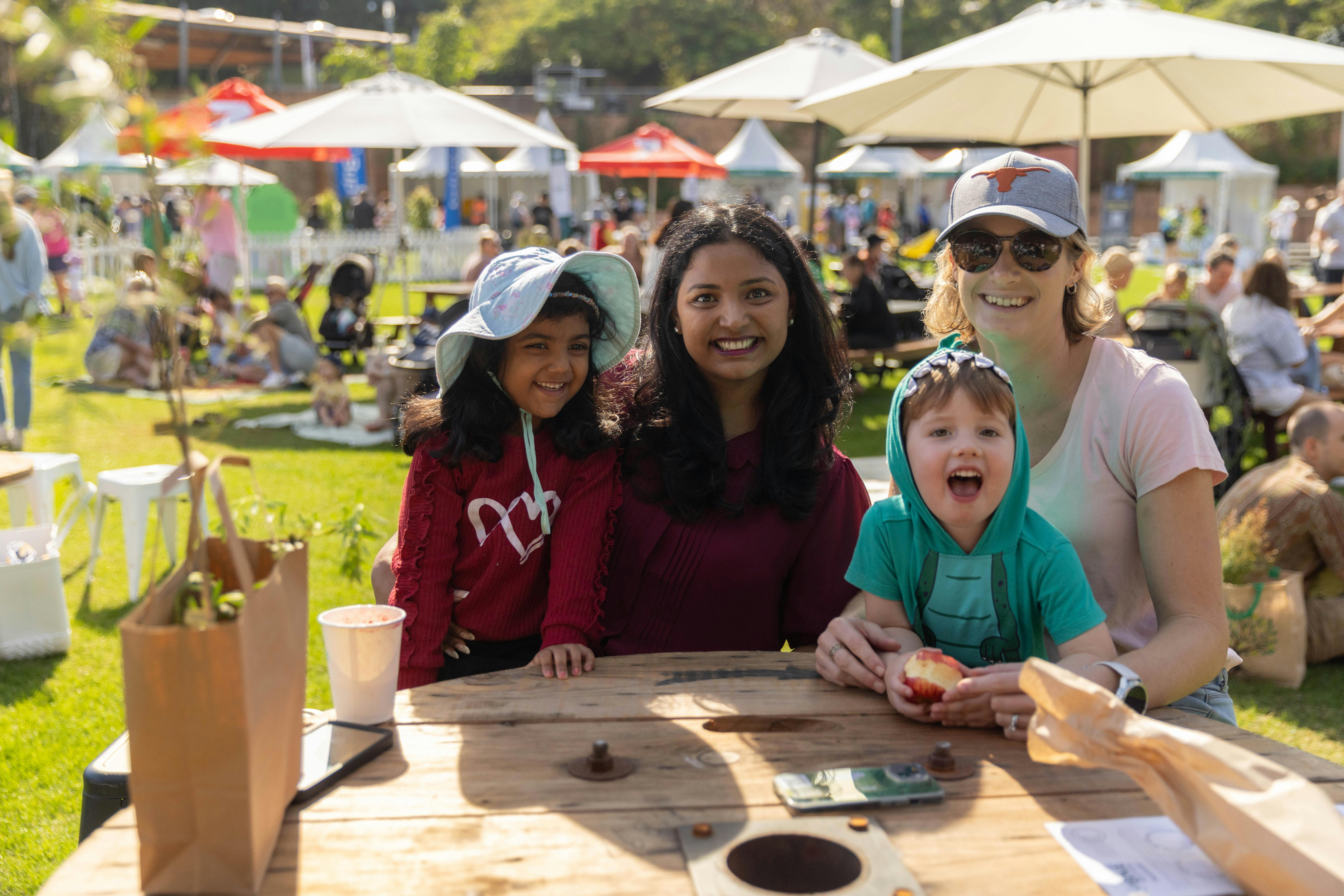 Two families sitting around a table at Sustainable BNE Festival