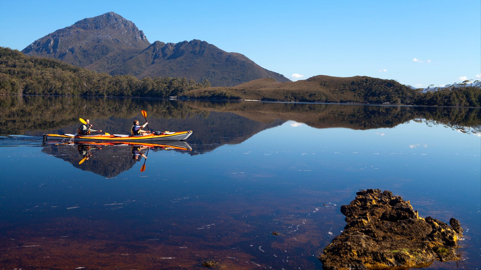 Kayakers on Forest Lagoon, Bathurst Harbour in Southwest Tasmania