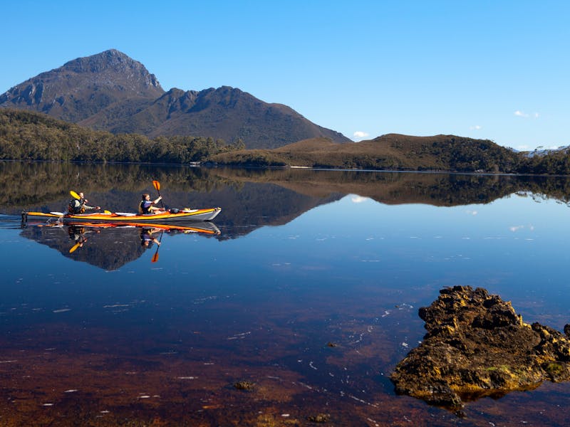 Kayakers on Forest Lagoon, Bathurst Harbour in Southwest Tasmania