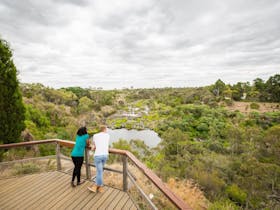 Two people looking over the land and the river