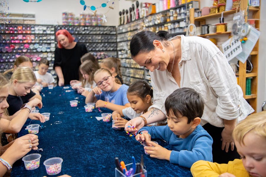 two women smiing helping children with beading workshop at Bead Shack Gerringong NSW