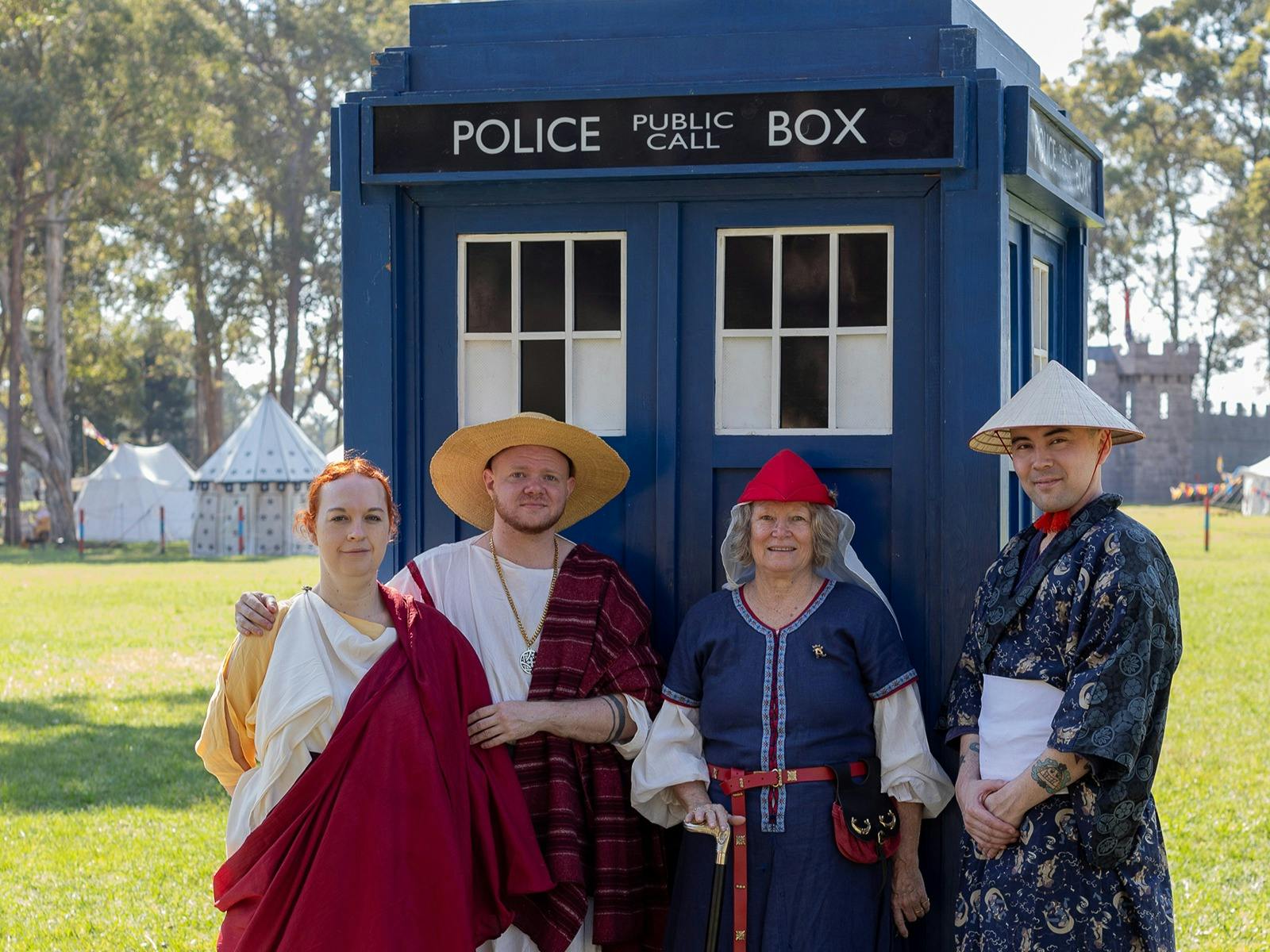 Visitors in Historical Costuming in front of a TARDIS