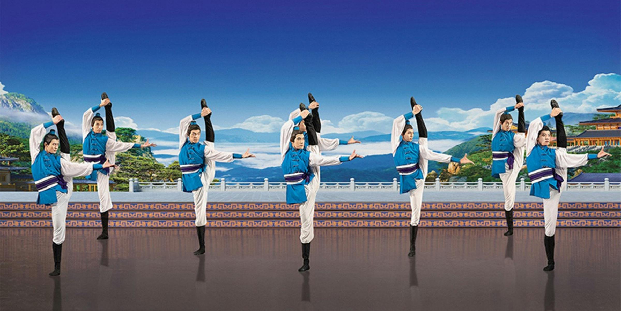 Classic chinese folk dance - Tibetan male dancers pose on one leg in front of a backdrop