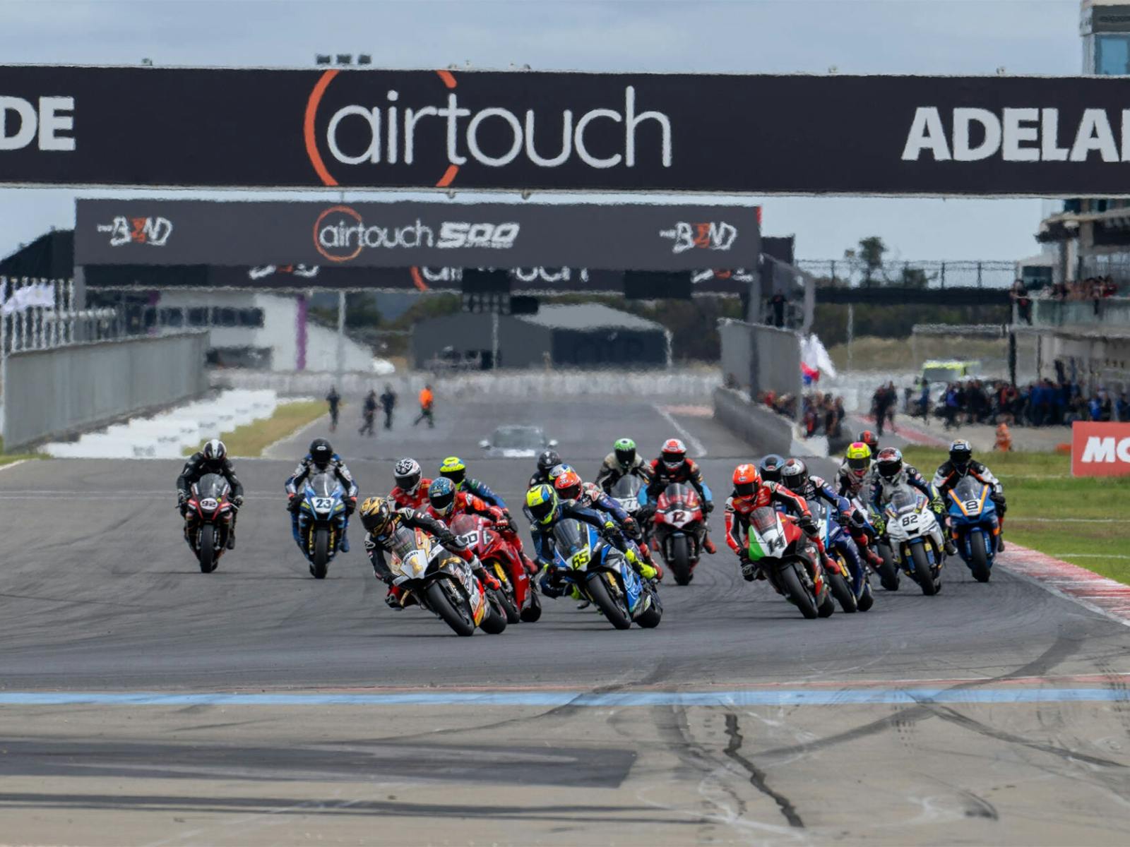 A group of Superbikes race around turn 1
