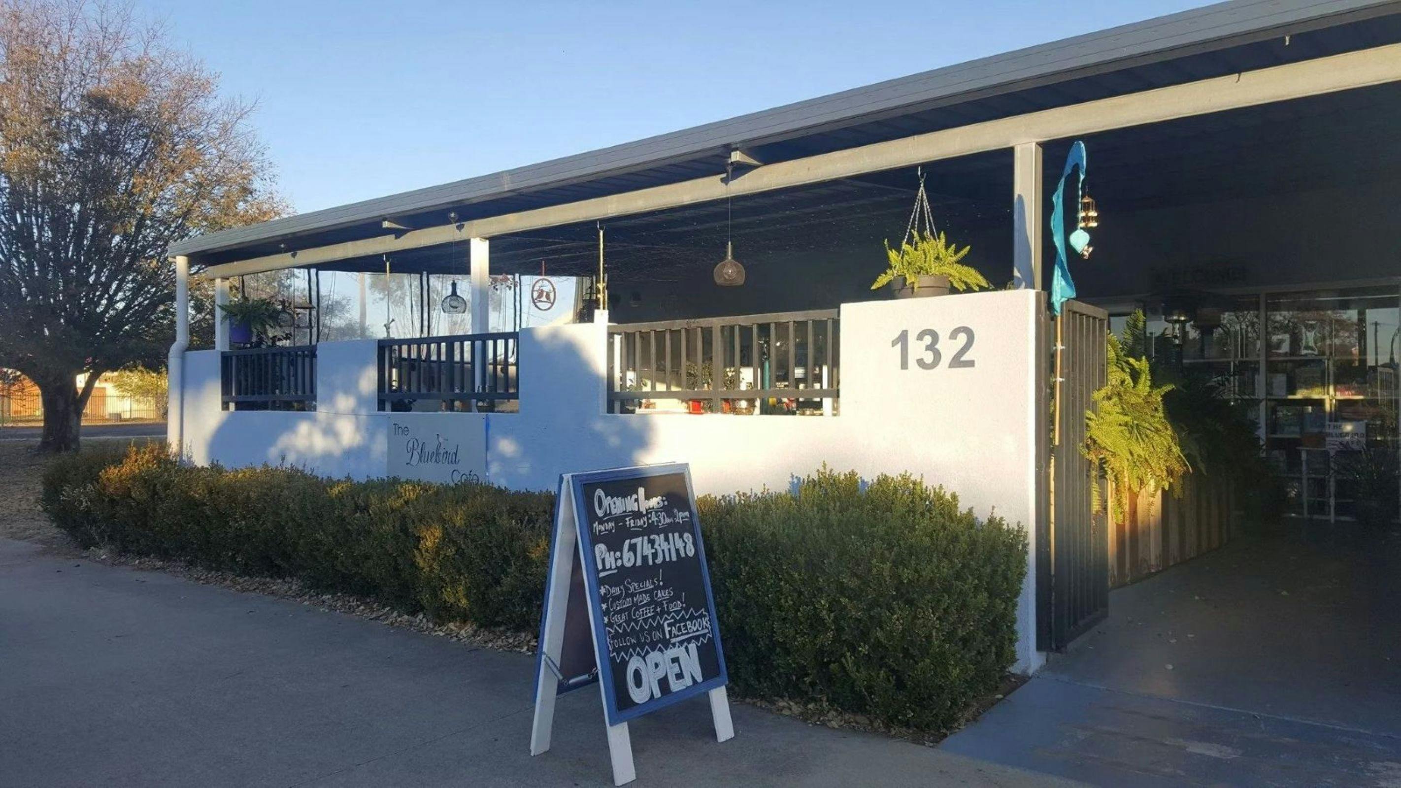 Front entry to cafe with ramp leading into courtyard
