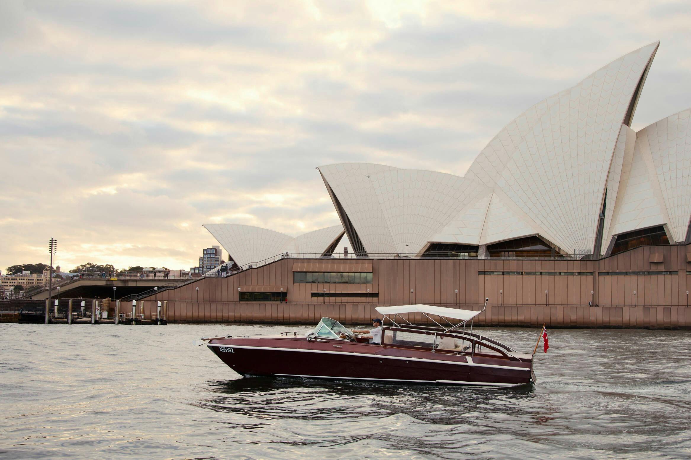 MV BEL private cruise on Sydney Harbour with Sydney city skyline and Harbour Bridge.